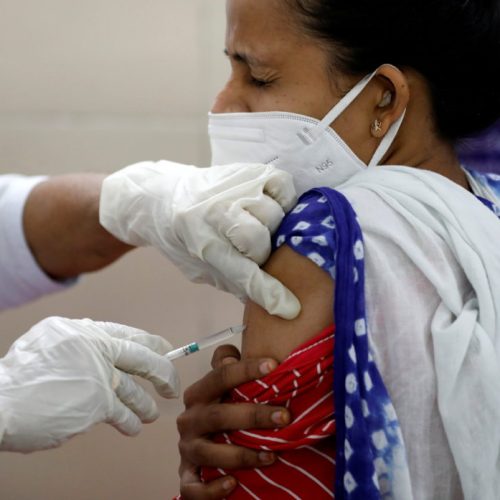 A healthcare worker reacts as she receives a dose of COVISHIELD, a COVID-19 vaccine manufactured by Serum Institute of India, during one of the world's largest coronavirus disease vaccination campaigns at a health centre in Jetalpur on the outskirts of Ahmedabad, India, January 16, 2021. REUTERS/Amit Dave